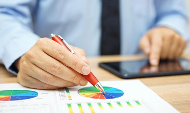 A person with a red pen and a tablet